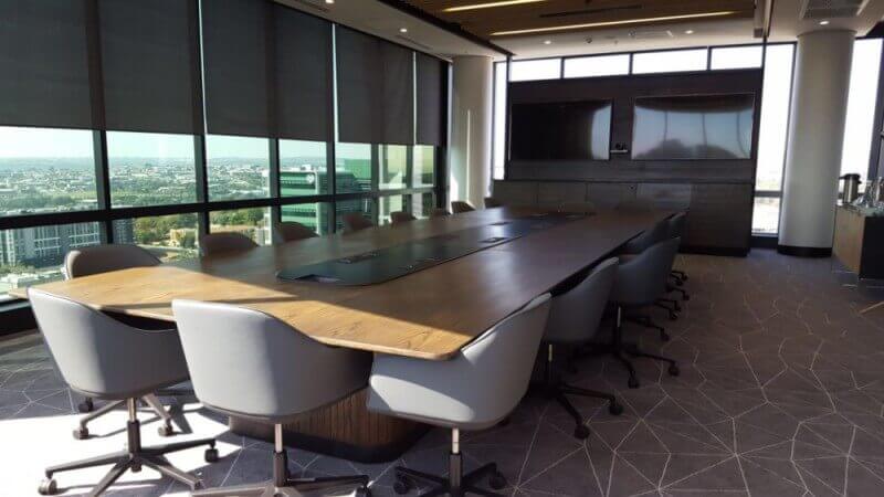 Conference room with long conference table finished with durable matte finish hardwax oil wood finish.