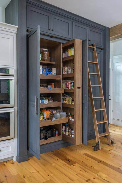 Custom stained rift and quartered white oak pantry cabinet in a kitchen.