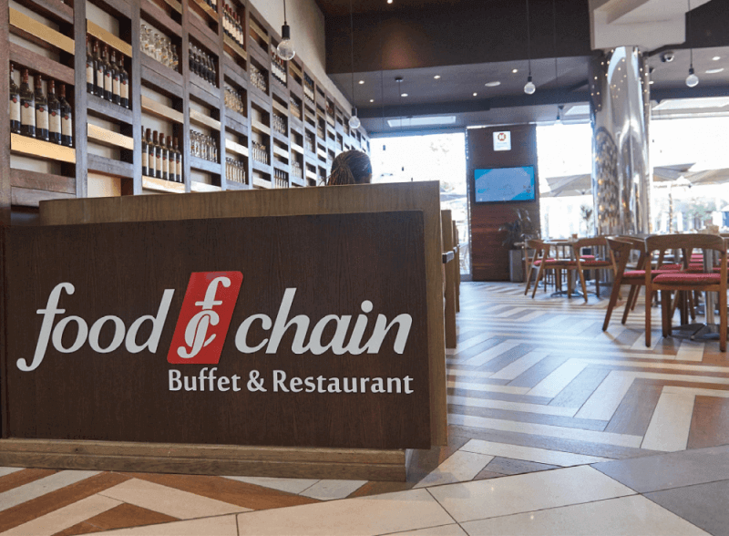 A restaurant sign made with wood background for the display.
