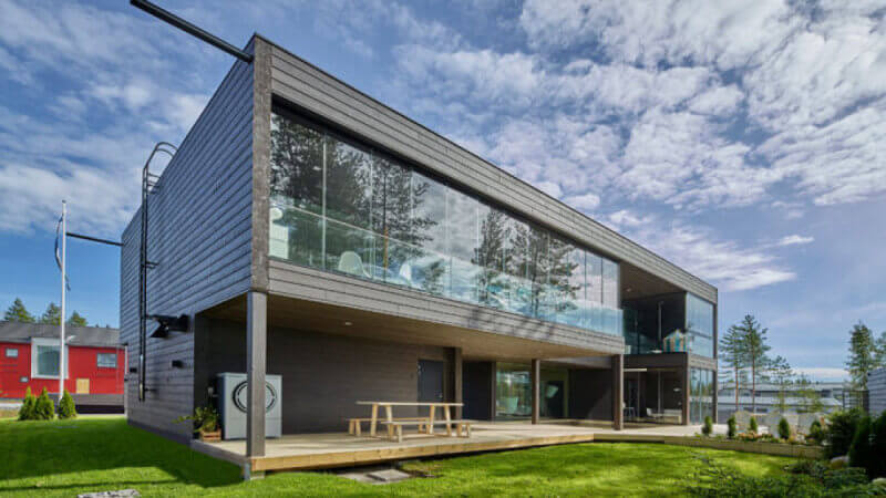 A modern design house with wood paneling finished using Rubio Monocoat wood exterior wood finish.