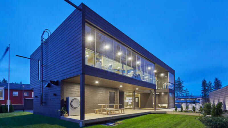 Modern architecture house with wood paneling at night.