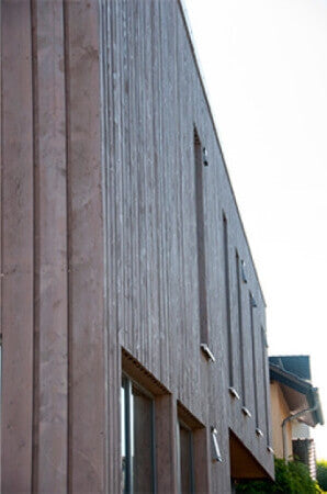 Exterior wood finish on wood paneled building.