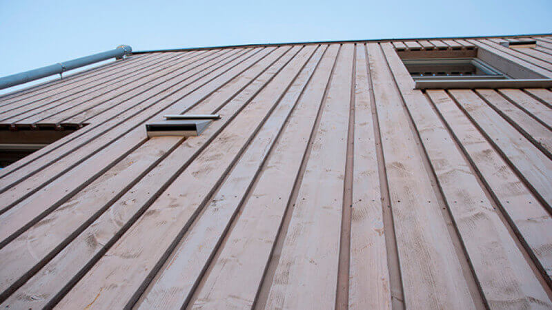 Exterior wood finish on wood paneled building.