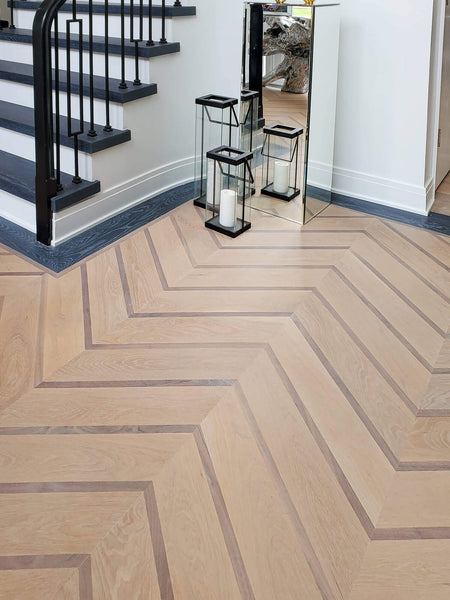 White oak and walnut chevron patterned hardwood flooring.