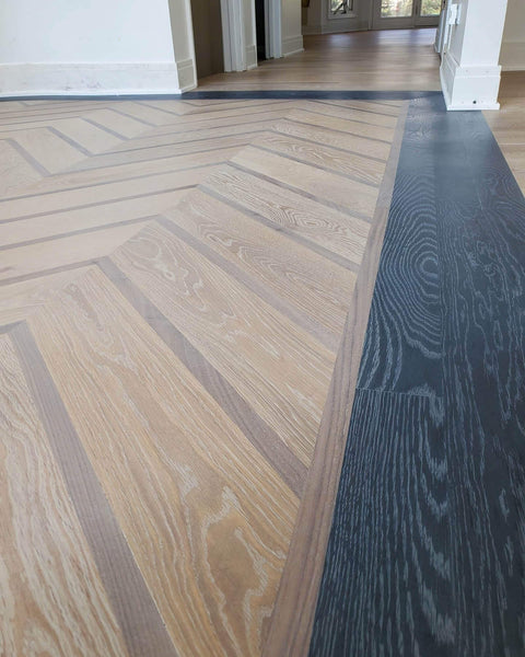 Chevron wood floors with a dark cersued wood border, finished with environmentally friendly oil wood finish.
