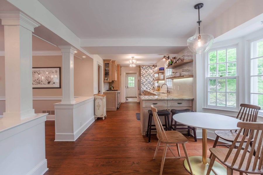 Kitchen with light rift sawn white oak cabinetry and dark warm floor.
