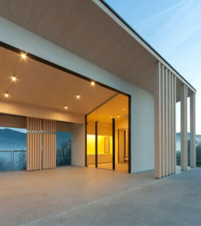A cemetery building with vertical wooden columns that provide support and create spaces.