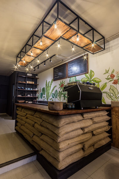 Custom coffee bar counter with sandbag walls and wood counters.