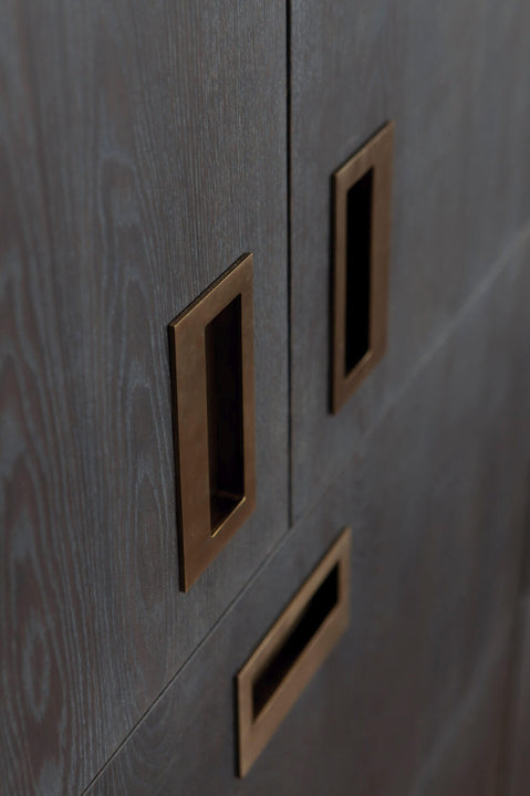 Flush mount dark brass drawer pulls.