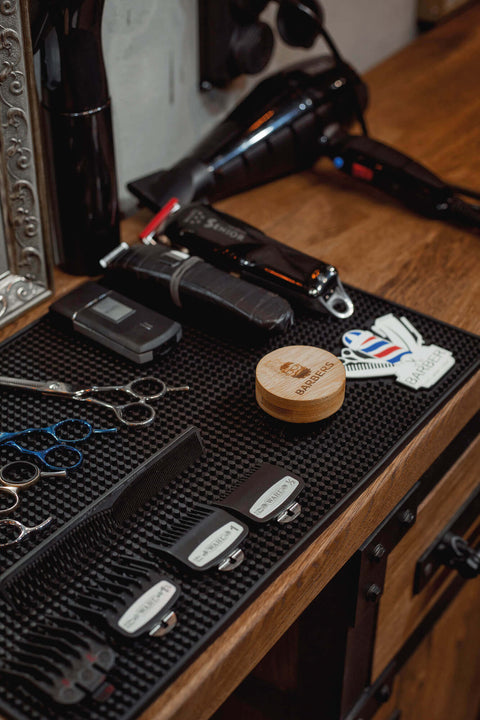 Detailed shot of barber tools sitting on a wood counter.