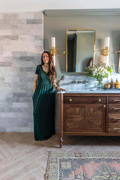 Jen Woodhouse stands next to the black walnut bathroom vanity she designed and built.
