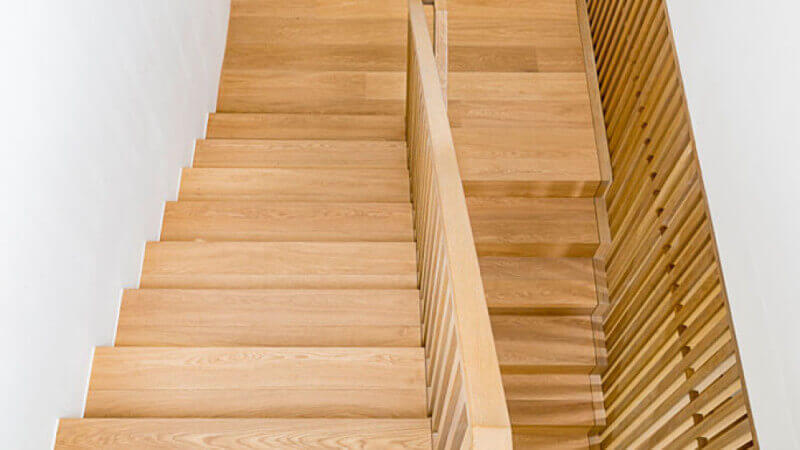 Oak stair treads with a durable natural wood finish on them.