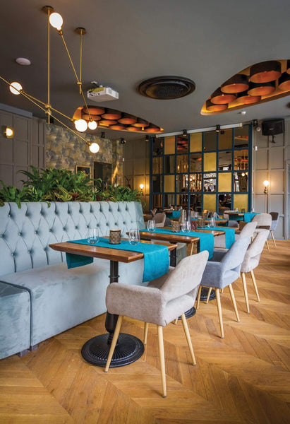 Wooden chevron flooring in a modern looking restaurant.