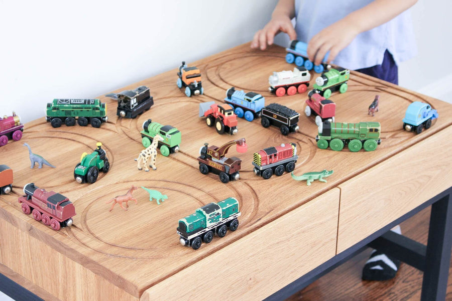 Custom children's train table finished with a toy safe wood finish.