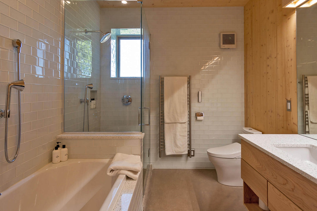 A modern bathroom with a tub and walk-in shower. This room features wood accents throughout finished with Rubio Monocoat Oil Plus 2C.