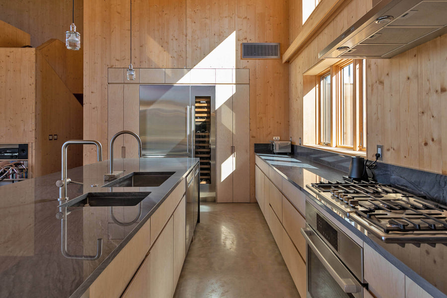 Kitchen with grey stone quartzite countertops. Baltic birch kitchen cabinets finished with Rubio Monocoat Oil Plus 2C.