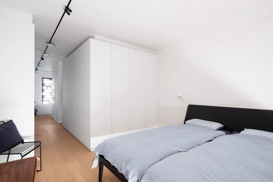 Bright minimal bedroom with white oak flooring finished with a natural wood oil.
