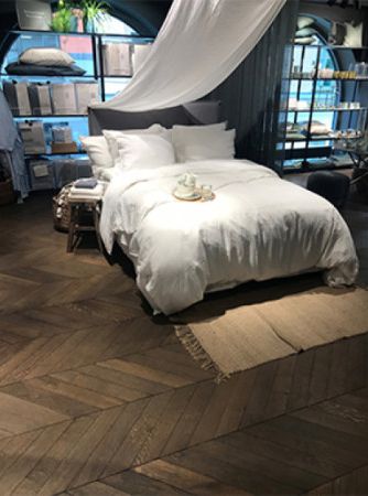 Bed on beautiful parquet wooden floors finished with Rubio Monocoat.