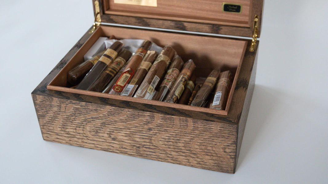 Cigars stored in a handcrafted white oak humidor finished with a natural wood finish.
