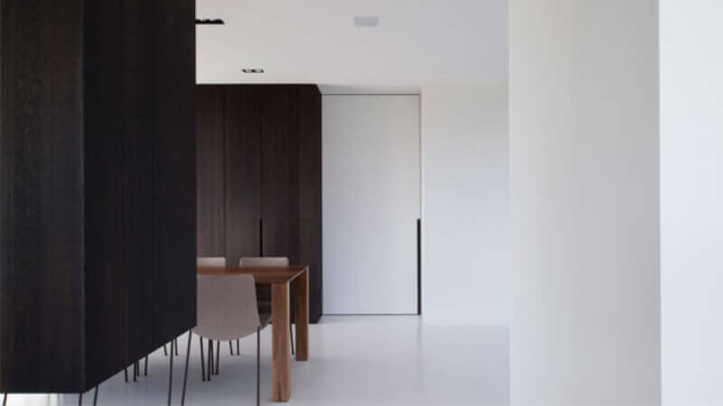 Very dark wood cabinets in a living room and dining room.