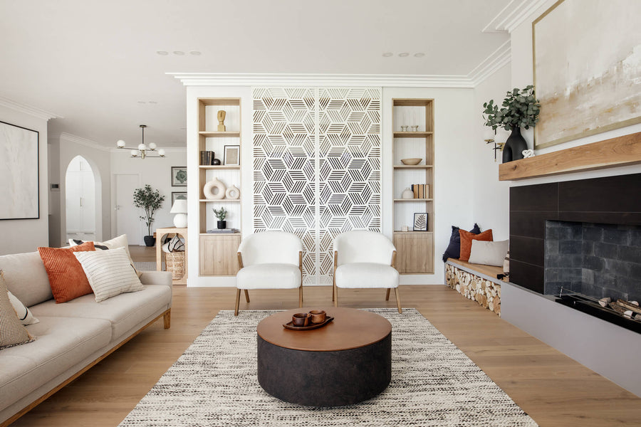 A living room at the Lignum residence featuring a white oak mantel, wood flooring and a beige sofa.