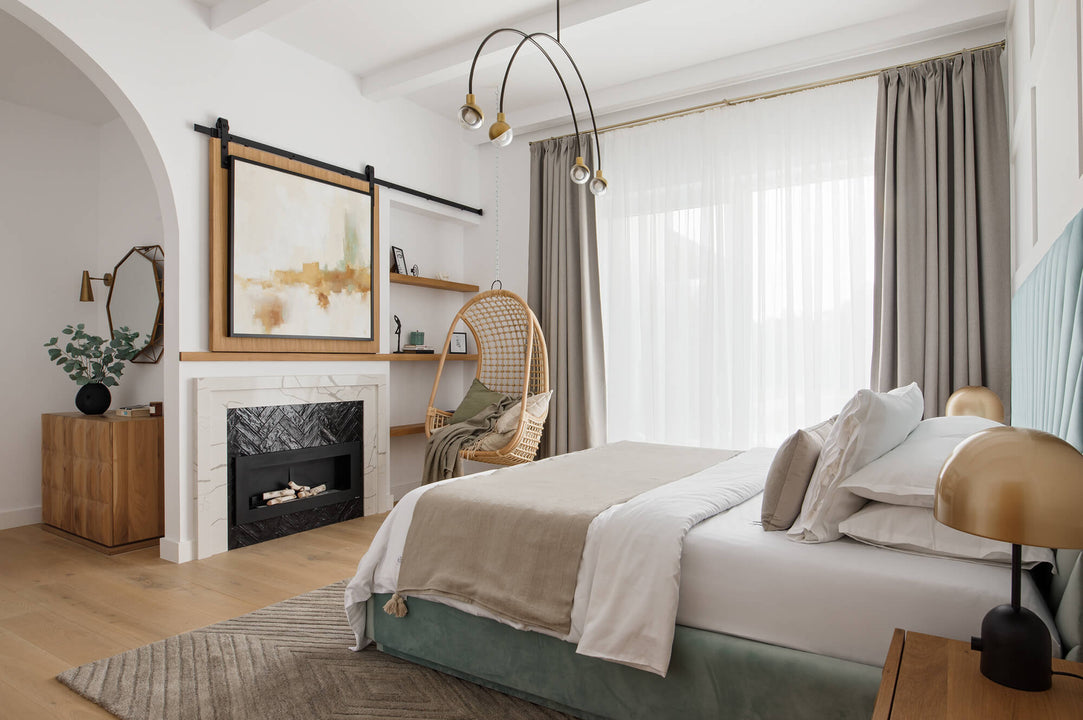 A beautiful fireplace in the master bedroom. Also in the room are several white oak furniture pieces finished with a wax wood coating.