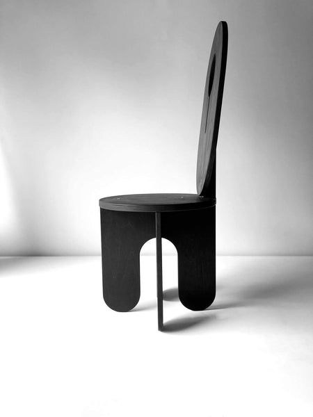 A side view of a modern black stool crafted from birch and finished with Rubio Monocoat products.