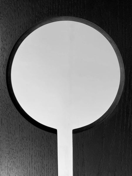 A detail shot of a keyhole-inspired element of a stool crafted from birch.