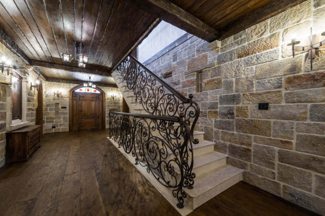 Beautiful stone walls contrast with wooden floors and ceiling finished with Rubio Monocoat.