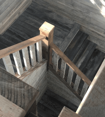 A wood staircase finished in a cerused look created using hardwax oil wood finish.