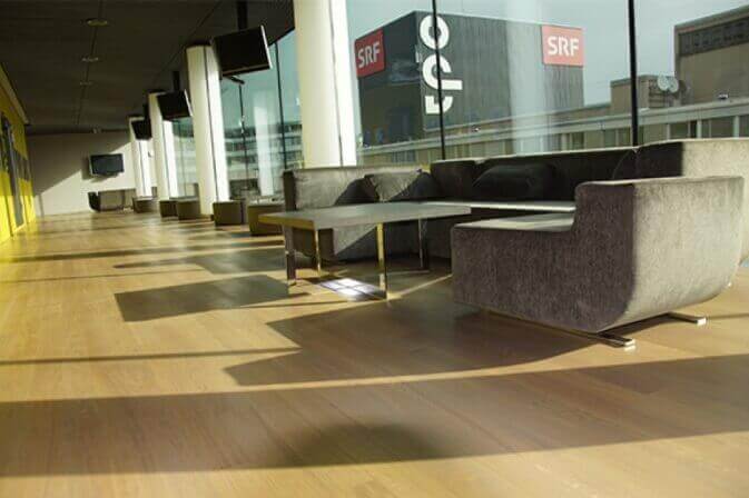 Hardwood flooring in a commercial lounge.