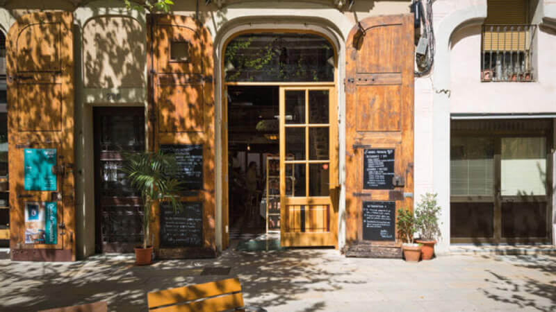 Front door of beautiful restaurant in Barcelona that features wood finished with Rubio Monocoat.