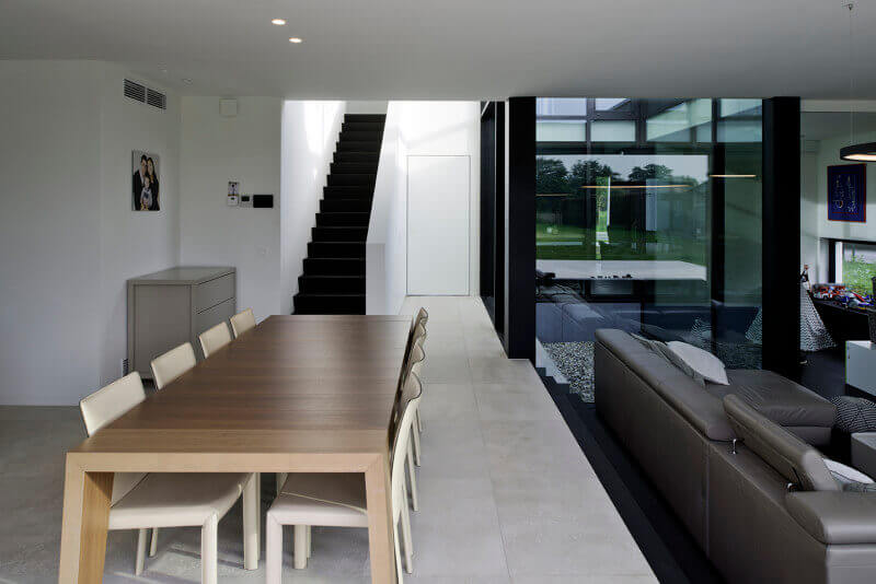 Dark stair treads leading out of a kitchen.