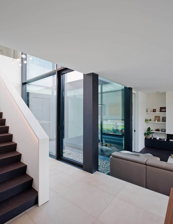 Dark stair treads leading down to a tiled landing.