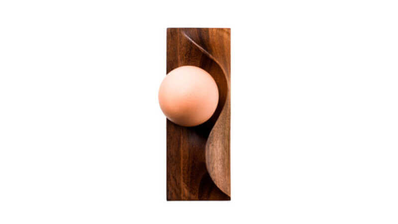 A walnut wood single egg serving dish finished with a plant-based hardwax oil wood finish.