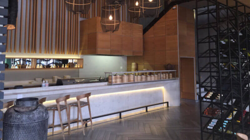 Herringbone wood flooring in a modern designed sushi restaurant.