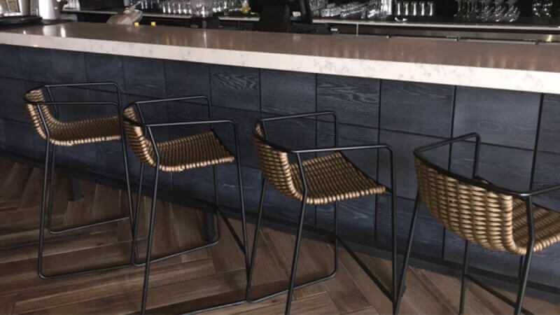 Front panels on a bar counter that are finished with a cerused look from Rubio Monocoat products.
