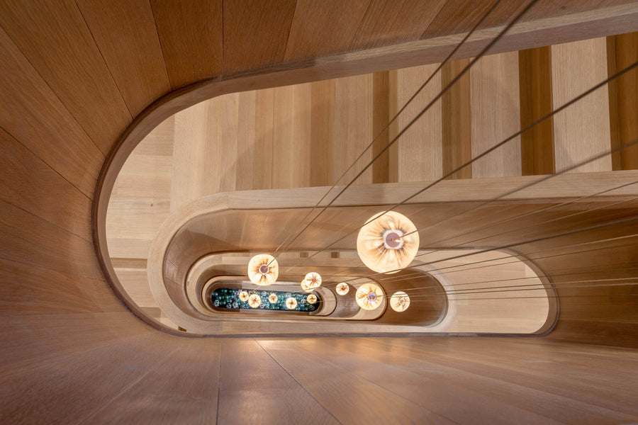 View down the middle of a spiraling wooden staircase.