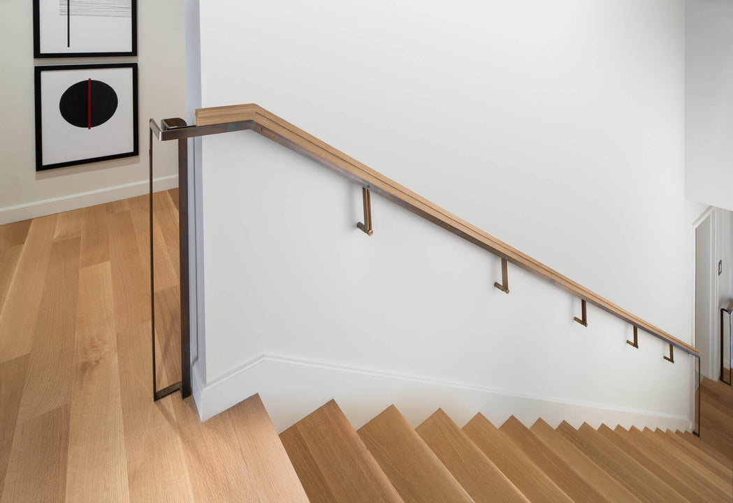 Rift sawn white oak stairs with wooden hand rail.