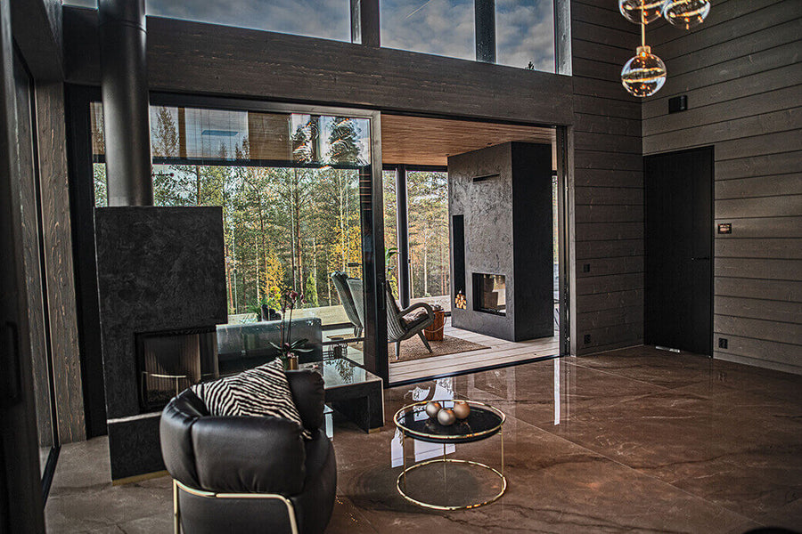 Luxury home interior with big glass windows viewing the forest