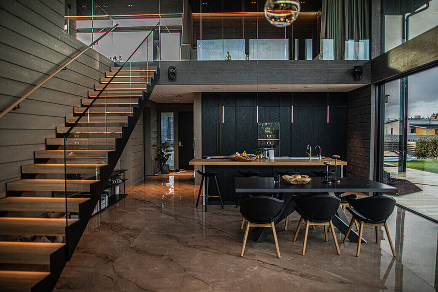 Modern open interior kitchen with natural lighting and a staircase