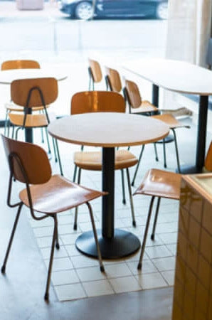 A table in a restaurant with a plant-based wood finish by Rubio Monocoat applied to it.