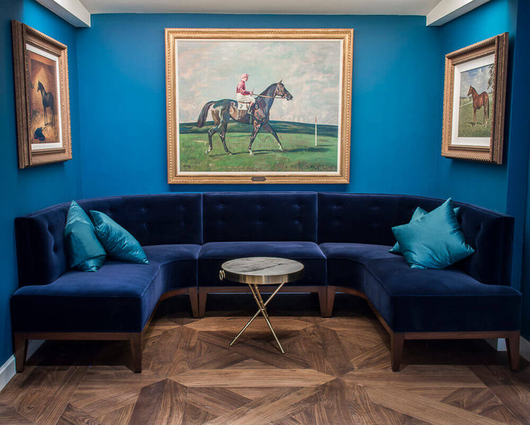 Walnut wood floor with blue walls and lounge chairs.