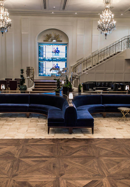 Walnut parquet flooring and stairs in a race track lounge.