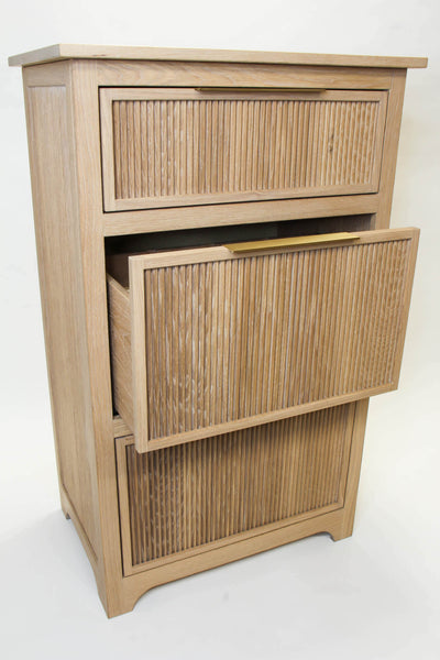 Overview image of the white oak reeded storage dresser with one drawer extended slightly.