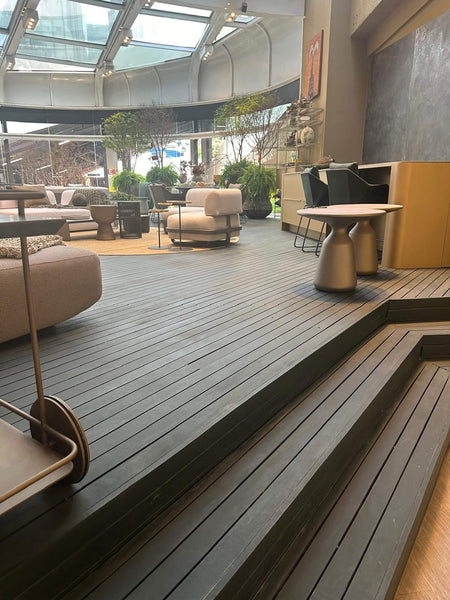 Wood decking with two steps in a home furnishing show room. The decking is made from cumaru wood and finished with DuroGrit, a durable wood stain and finish all in one coat.