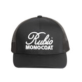Black cap with Rubio Monocoat logo on a white surface