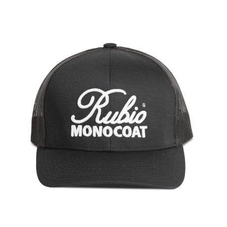Black cap with Rubio Monocoat logo on a white surface