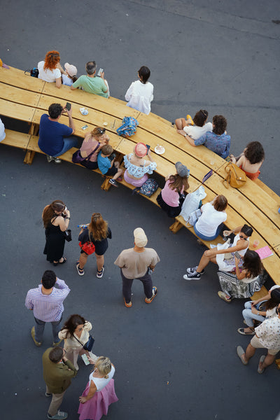 Many people sitting at an outdoor table with a unique shape finished with DuroGrit exterior wood stain and finish in one.