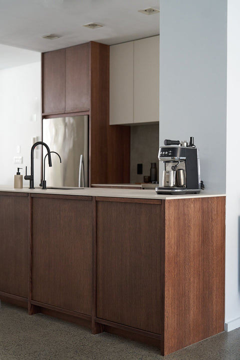 A contemporary modern kitchen complete with white oak lower cabinets finished with a brown wood finish and white upper cabinets.